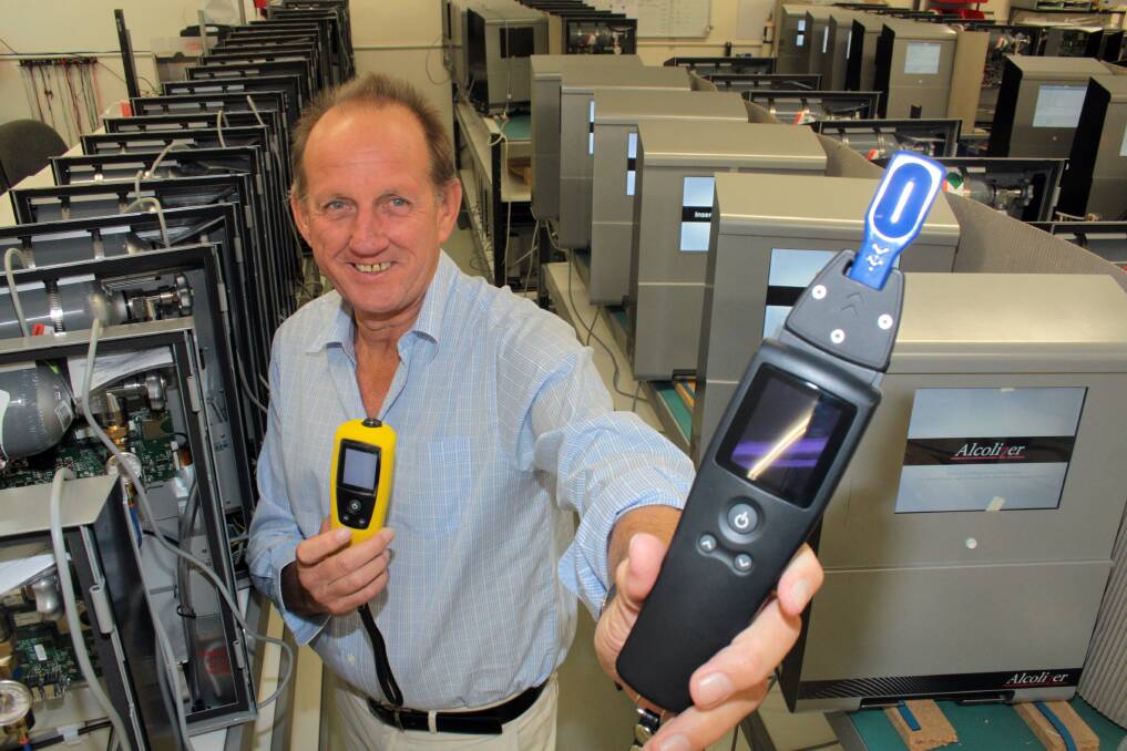 BREATHE?EASY:?Alcolizer chief executive Gary Johnson with one of their breathalyser's (in yellow) and the new unit that can test both drug and alcohol levels. 
Photo: Chris McCormack