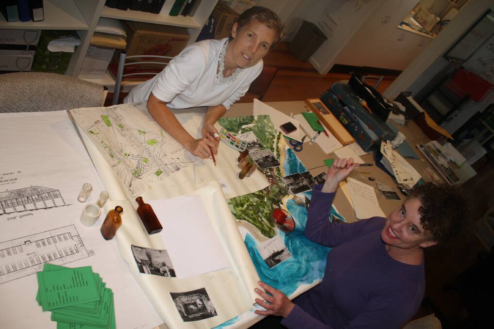 HISTORY LESSON:?Artist Jo Kaspari (left) and North Stradbroke ISland Museum researcher Elisabeth Gondwe put the finishing touches on the board game, which was funded by a Regional Arts Development Fund grant.