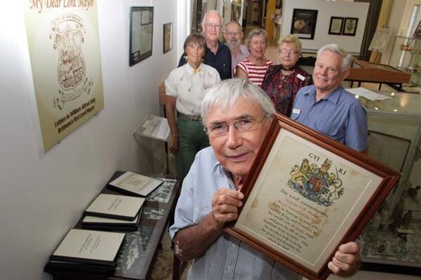 Emeritus Professor Bob Milns, front, examines the exhibits in Redland Museum's Scribo Scriptus exhibition with, left to right, Sandra Davis, Arthur Bowell, Diane Gillham, Mick Bright, Kath McNeilly and Ross Bower.