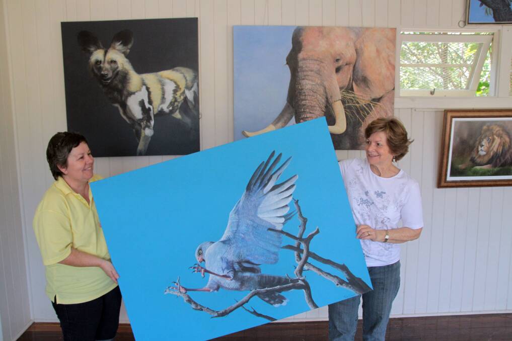 Sandra Temple and Gail Higgins prepare to hang Paula Wiegmink of Perth's work entitled 'To the Point' which will be exhibited at the Old Schoolhouse Gallery.Photo by Chris McCormack