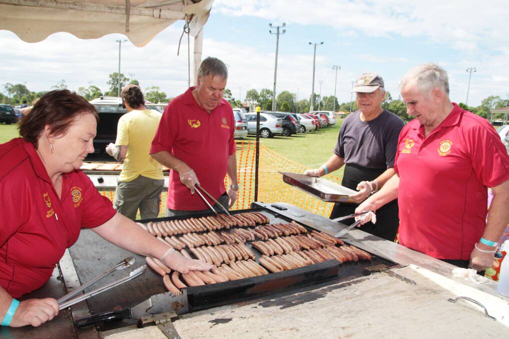 Heating up… Rotary Club of Redlands volunteers Shirley Rhodes, David Mcinnes, navy reserve volunteer Graeme Rodgers and Dusty Rhodes cooked up a storm, helping serve thousands of sausages.