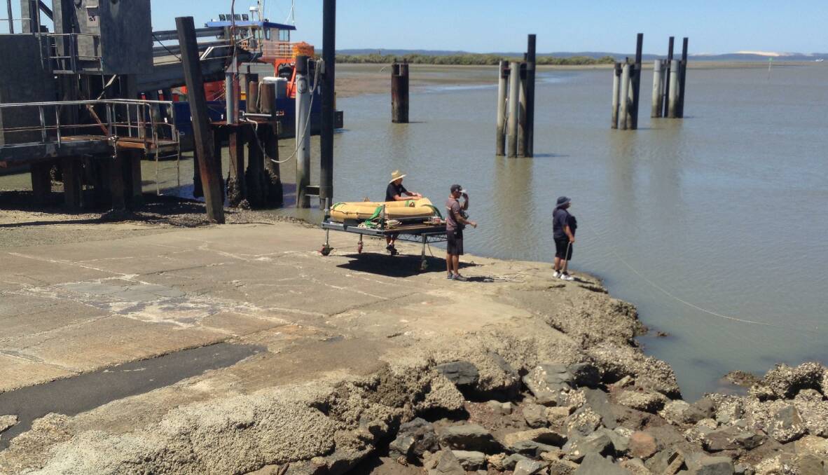 An inflatable raft is readied to bought onto a ferry.