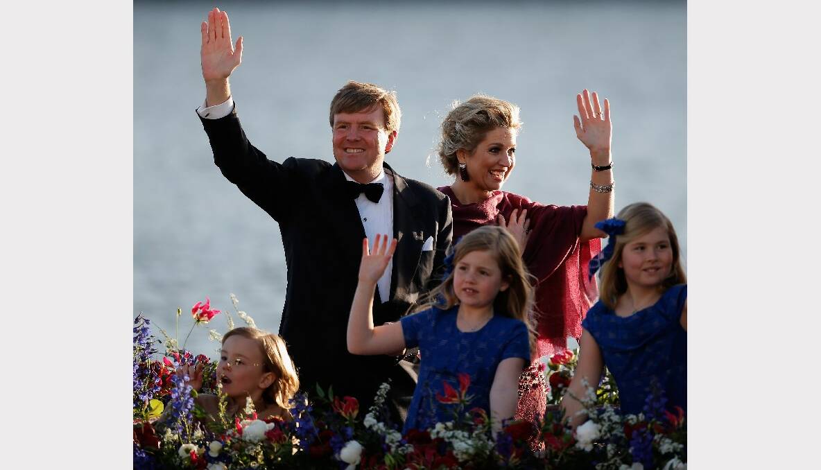   King Willem Alexander of the Netherlands, Queen Maxima of the Netherlands and their daughters Princess Catharina Amalia, Princess Ariane and Princess Alexia of the Netherlands wave to the crowd along the bank aboard the King's boat for the water pageant to celebrate the inauguration of King Willem of the Netherlands after the abdication of his mother Queen Beatrix of the Netherlands on April 30, 2013 in Amsterdam, Netherlands.  (Photo by Dean Mouhtaropoulos/Getty Images)