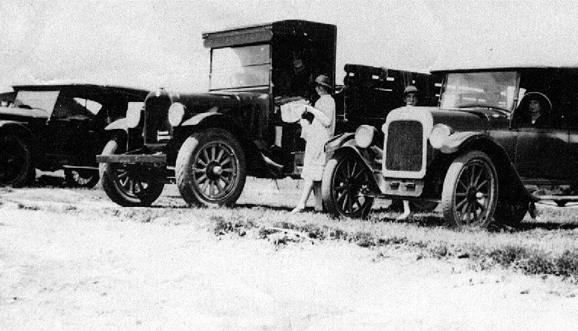 Vehicles used by Banks Transport company. Edna Banks beside the truck at  Wellington Point in late 1920s