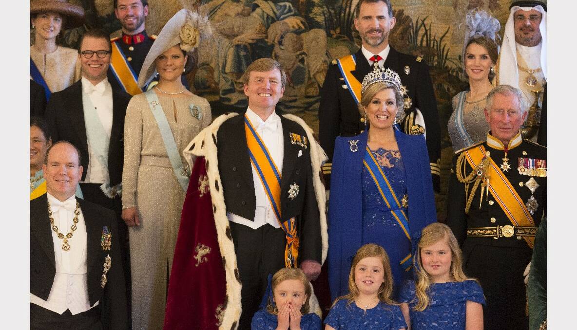  King Willem Alexander and Queen Maxima of the Netherlands pose with guests.