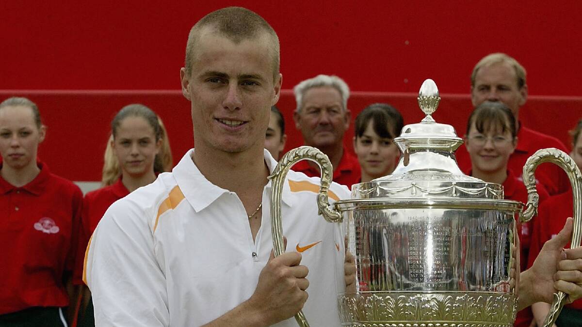 2002: Lleyton Hewitt of Australia celebrates with the trophy after victory over Tim Henman of Great Britain in the Final of the Stella Artois Championship. Photo by Phil Cole/Getty Images