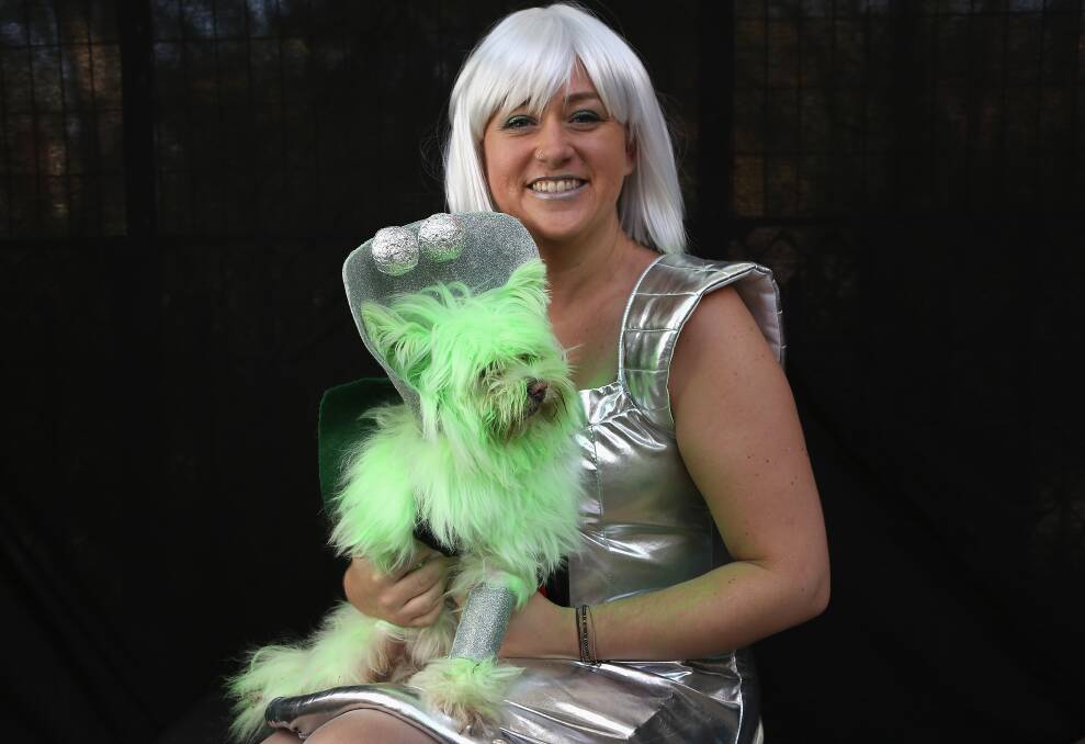 Nichole Hallberg holds her dog Wilson, a rescued mixed breed posing as a Martian, at the Tompkins Square Halloween Dog Parade on October 20, 2012 in New York City. Photo by John Moore/Getty Images