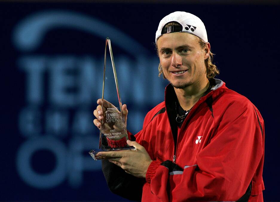 2007: Lleyton Hewitt of Australia poses for photographers with the winner's trophy after defeating Jurgen Melzer of Austria during the final of the Tennis Channel Open. Photo by Matthew Stockman/Getty Images