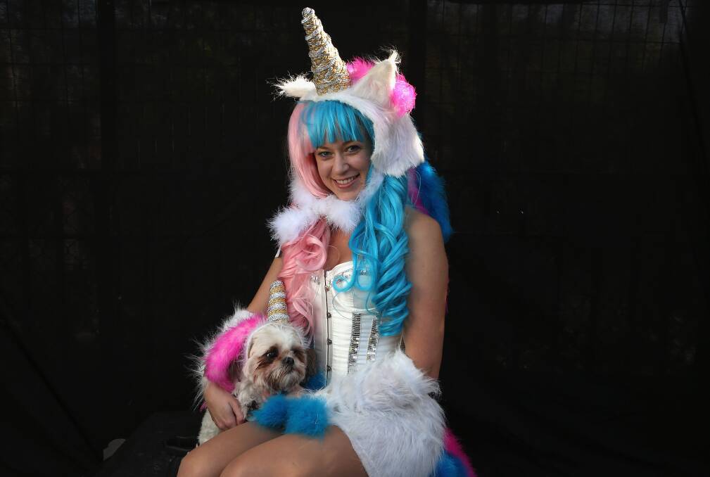 Jamae Hallberg and her Shih Tsu Femma pose as unicorns at the Tompkins Square Halloween Dog Parade on October 20, 2012 in New York City. Photo by John Moore/Getty Images