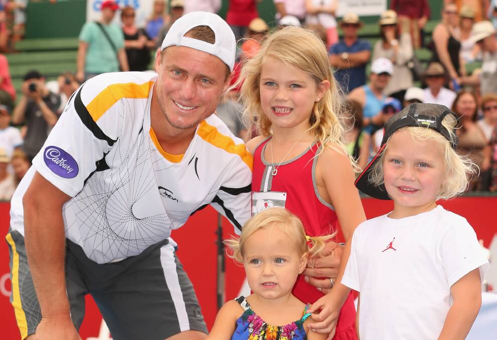 2012: Lleyton Hewitt of Australia poses with the winners trophy and his children Ava Hewitt, Cruz Hewitt and Mia Hewitt after winning his match against Juan Martín del Potro of Argentina at the AAMI Classic. Photo by Scott Barbour/Getty Images