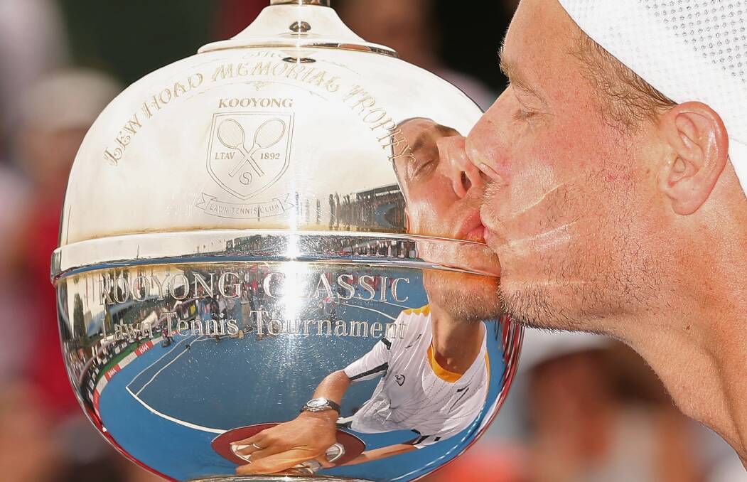 2012: Lleyton Hewitt of Australia kisses the winners trophy after winning his match against Juan Martín del Potro of Argentina during day four of the AAMI Classic at Kooyong. Photo by Scott Barbour/Getty Images