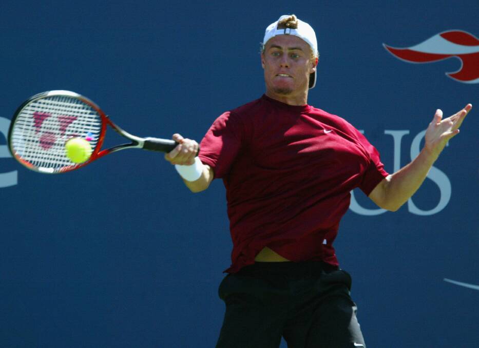 2003: Lleyton Hewitt returns a shot to Juan Carlos Ferrero of Spain during the US Open men's singles quarter-finals. Ferrero defeated Hewitt 4/6, 6/3, 7/6(5), 6/1. Photo by Alex Livesey/Getty Images
