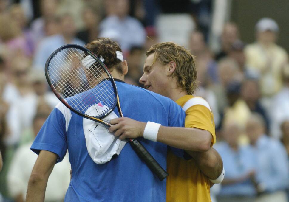 2004: Roger Federer received a hug from Lleyton Hewitt after winning the men's singles final at the US Open in New York. Photo by A. Messerschmidt/Getty Images